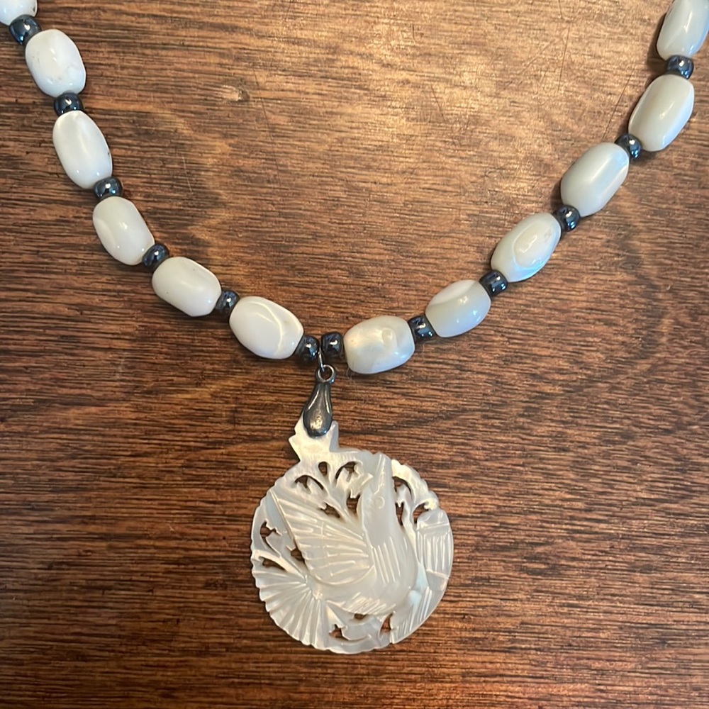 Mother of Pearl beaded necklace with carved bird pendant
